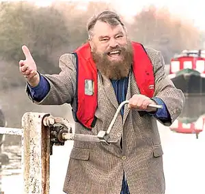 Crew member operating canal lock paddles